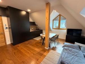 a living room with a table and a bedroom at Nordic Sun 01 in Kranjska Gora