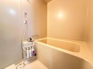 a small bathroom with a sink and a mirror at ura Yadokari House in Okayama +23 photos