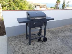 a grill sitting on a table next to a wall at Capomare2 in Capo Vaticano