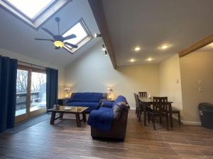 a living room with a blue couch and a table at Mountain Home at Camelback in Tannersville