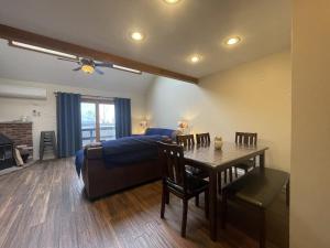 a bedroom with a bed and a table and a dining room at Mountain Home at Camelback in Tannersville