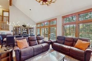 a living room with brown leather couches and a table at Vista at Camelback Mountain in Tannersville