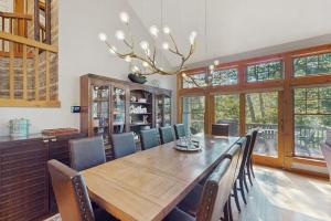 a dining room with a wooden table and chairs at Vista at Camelback Mountain in Tannersville