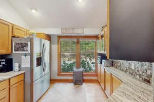a kitchen with a stainless steel refrigerator and a window at Vista at Camelback Mountain in Tannersville +27 photos