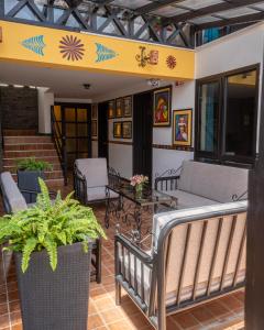 a porch with chairs and a couch and a table at Tika Wasi Casa Boutique in Cusco