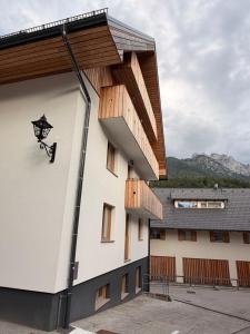 a building with a balcony on the side of it at Nordic Sun 01 in Kranjska Gora