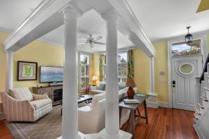 a living room with a couch and a table at Avonlea Cottage in Saint Simons Island