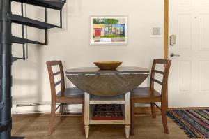 a dining room table with two chairs and a bowl on it at Restful Rockies Overlook in Steamboat Springs
