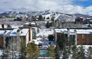a city covered in snow with mountains in the background at Restful Rockies Overlook in Steamboat Springs