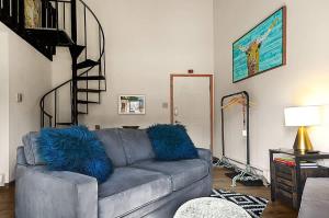 a living room with a gray couch with blue pillows at Restful Rockies Overlook in Steamboat Springs +24 photos
