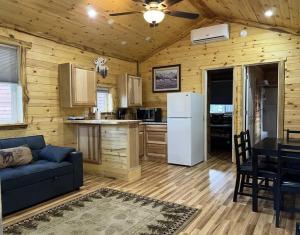 a living room with a blue couch and a kitchen at Rimrock Lodge LLC in Thompson Falls