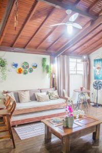 a living room with a couch and a table at CHALÉ ADOBE in Carrancas