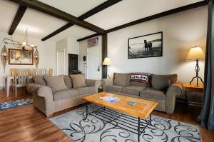 a living room with two couches and a table at Rockies Alpine Haven in Steamboat Springs