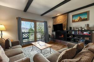 a living room with two couches and a television at Rockies Alpine Haven in Steamboat Springs