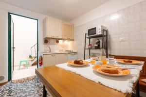 a kitchen with a table with two plates of food on it at Rifugio del Sole in Cutrofiano