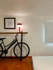 a bike on a stand in a room with a lamp at A&D Houses No3 in Patra