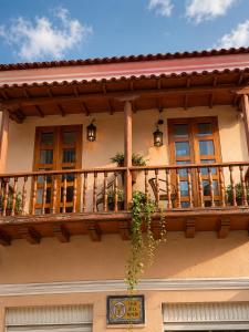 a balcony of a house with windows and plants at ETHNIC Thematic Hotel in Cartagena de Indias