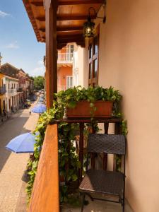 a balcony with a bench and potted plants on it at ETHNIC Thematic Hotel in Cartagena de Indias +31 photos