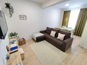 a living room with a brown couch and a table at Airtegal A Capelada Cedeira in Cedeira