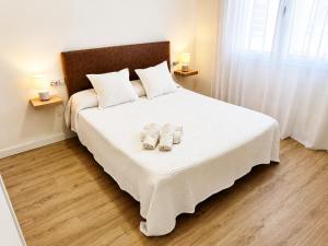 a bedroom with a bed with two towels on it at Airtegal A Capelada Cedeira in Cedeira