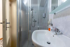 a bathroom with a white sink and a shower at Rifugio del Sole in Cutrofiano +36 photos