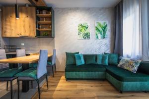 a living room with a green couch and a table at G apartments in Gevgelija