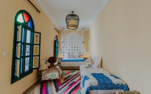 a bedroom with two beds and a window at The Little Hara in Marrakesh