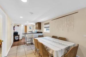 a kitchen and dining room with a table and chairs at 4BR Bungalow Steps to the Beach in Seaside Heights +7 photos