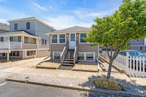 a house with a staircase in front of it at 4BR Bungalow Steps to the Beach in Seaside Heights