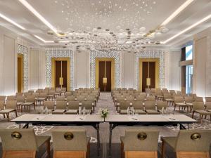 a large room with rows of tables and chairs at Sofitel Riyadh Hotel & Convention Centre in Riyadh +183 photos