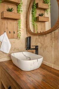 a bathroom with a large white bowl sink on a wooden counter at EnergyZen - Spa Alsace - le Refuge des Anges in Bischoffsheim +36 photos