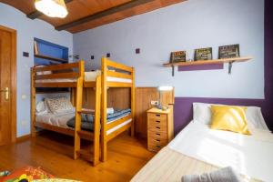 a bedroom with two bunk beds and a desk at Casa rural en Terra Alta con vistas al Tossal d'Engrilló, cerca de la Vía Verde, espacios exteriores, doble barbacoa, ideal para familias, grupos y mascotas in Prat de Compte +63 photos