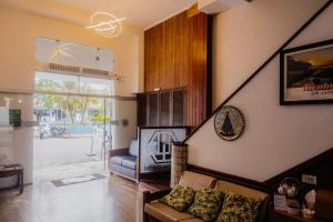 a living room with a couch and a chair at Hotel São Charbel in Ubatuba