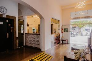 a room with a store with a clock on the wall at Hotel São Charbel in Ubatuba