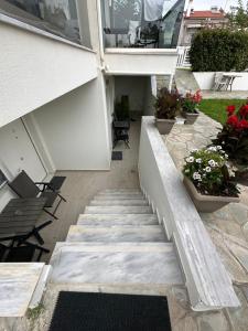 a staircase leading up to a house with flowers at Villa Nikiti View semi-basement in Nikiti +9 photos