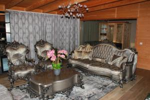 a living room with a couch and two chairs and a table at Batllava Premium Resort Villa's in Orllan +1 photo