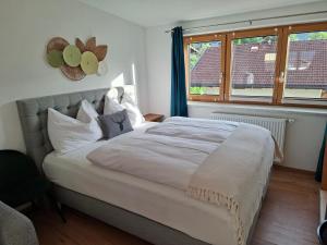 a bedroom with a bed with white sheets and a window at Lovely Rita Studio, modern Studio - balcony and mountain view - center Kaprun in Kaprun