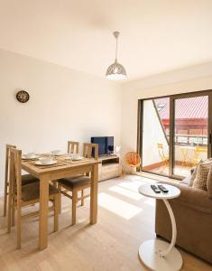 a living room with a table and a couch at Airtegal Atico Mar de Cedeira in Cedeira +8 photos