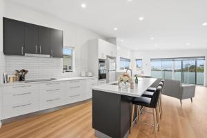 a kitchen with white cabinets and a table and chairs at Stylish Rosetta River Escape in Rosetta