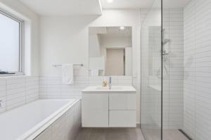 a white bathroom with a sink and a shower at Stylish Rosetta River Escape in Rosetta +27 photos