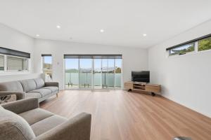 a living room with a couch and a television at Stylish Rosetta River Escape in Rosetta