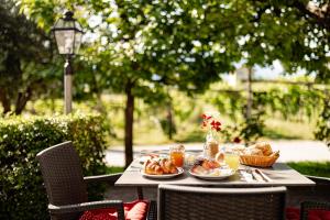 a table with plates of food on it at Kalterer See Hof in Caldaro