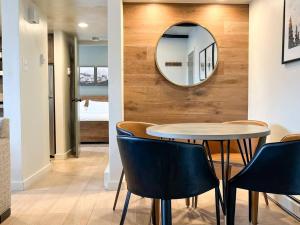a table and chairs in a room with a mirror at Alpenglow Bungalow in Steamboat Springs