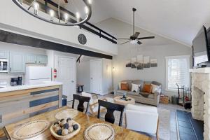 a kitchen and living room with a table and chairs at The Pocono Loft in Lake Harmony