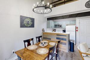 a kitchen and dining room with a wooden table and chairs at The Pocono Loft in Lake Harmony