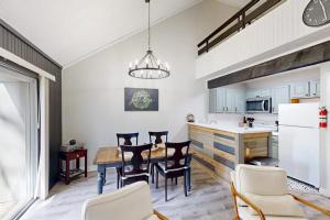 a kitchen and dining room with a table and chairs at The Pocono Loft in Lake Harmony