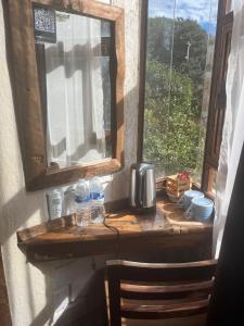a window with water bottles on a wooden ledge at La Misión Hotel Chignahuapan in Chignahuapan +26 photos
