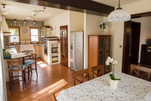 a kitchen and living room with a table and chairs at Villa Corvina in Győrújbarát