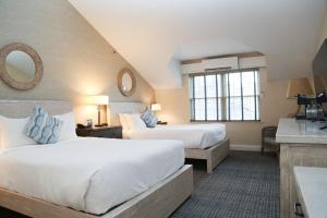 a hotel room with two beds and a sink at Edgar Hotel Martha's Vineyard, an Ascend Collection Hotel in Edgartown