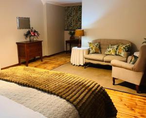 a living room with a bed and a couch at The Orchard in Hilton +12 photos